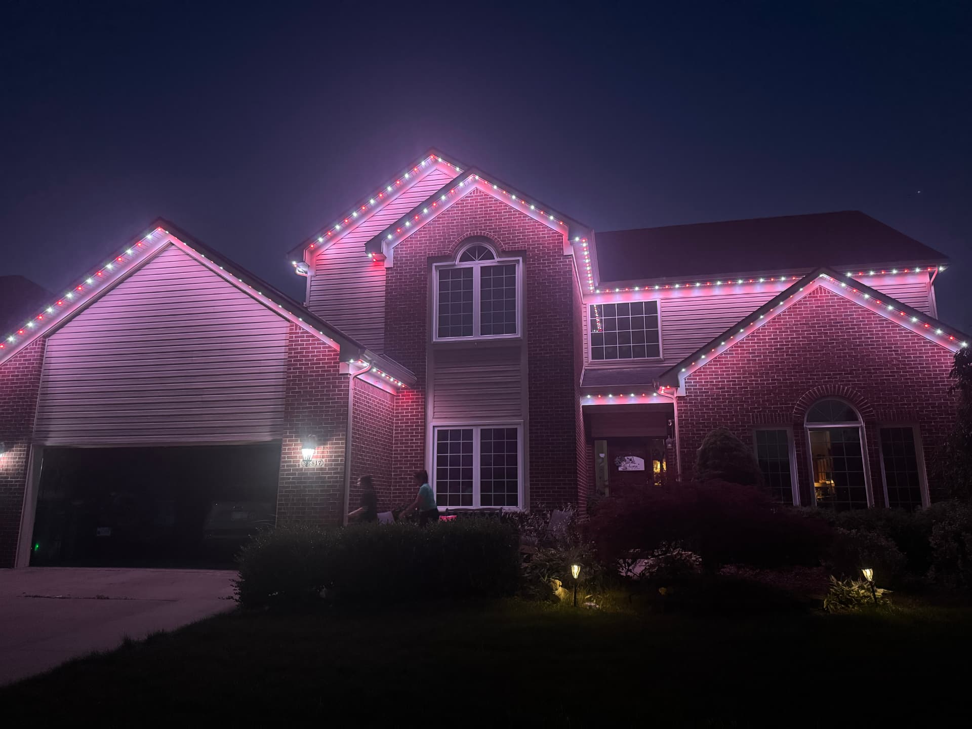 Home glowing in pink and red LED lighting for a special occasion